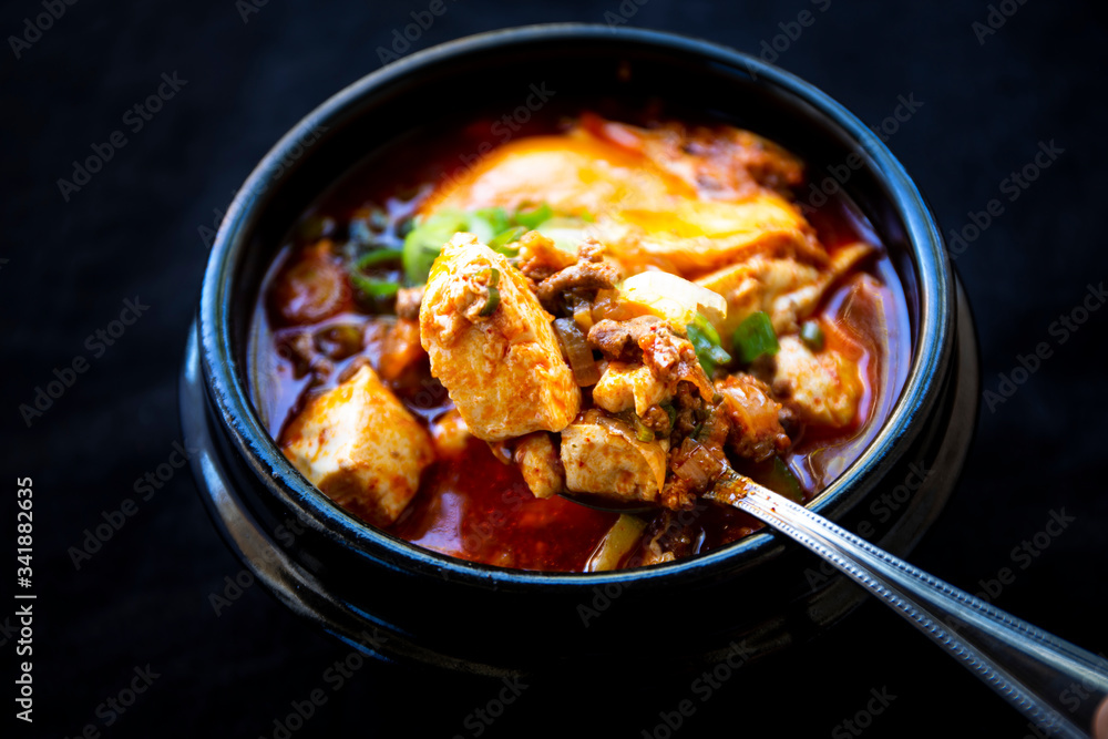 Korean spicy silken tofu stew which is called Sundubu Jjigae Korean spicy silken tofu stew which is called Sundubu Jjigae