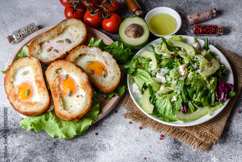 Delicious breakfast with grunts, eggs, avocado and cherry tomatoes