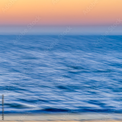 textured sunset over the sea with orange sky. blurred motion - Abstract