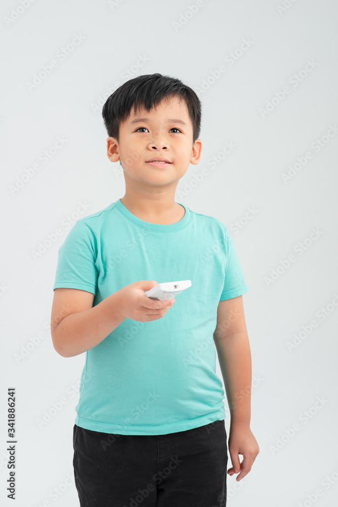 Portrait of young small boy holding remote controller Portrait of young small boy holding remote controller