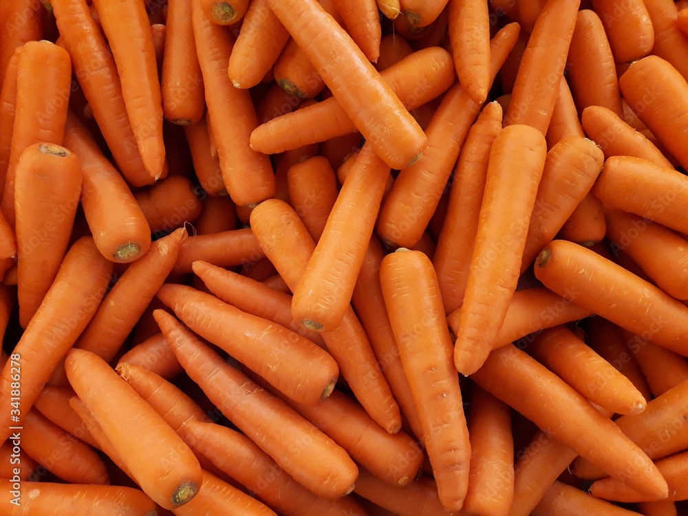 Pile of carrots on market stall. Pile of carrots on market stall.