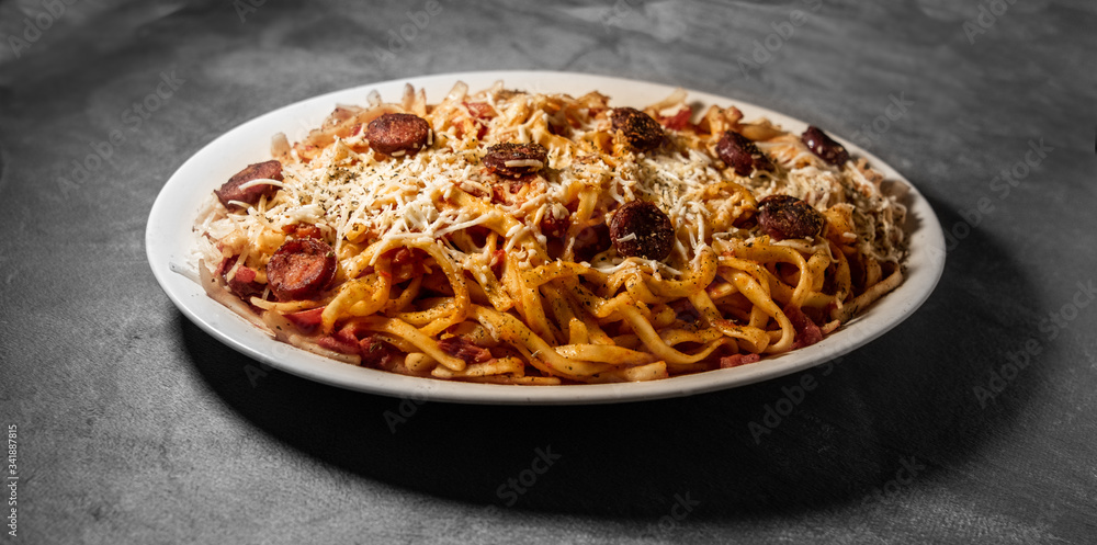 Italian scialatielli pasta with sausages, fresh tomato and cheese Italian scialatielli pasta with sausages, fresh tomato and cheese