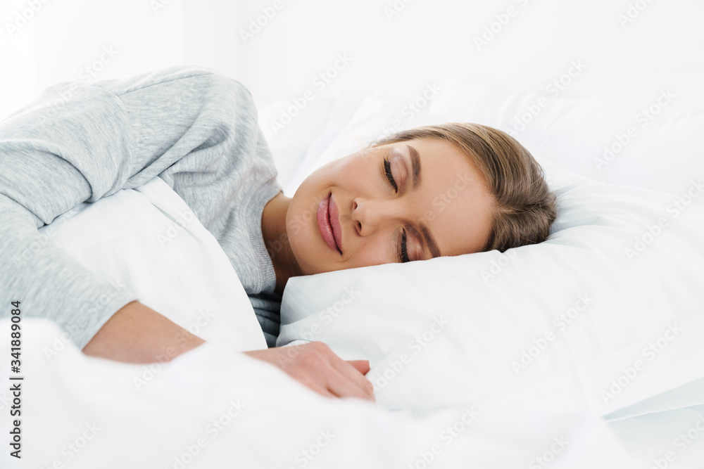 Image closeup of cute young woman lying and sleeping in bed Image closeup of cute young woman lying and sleeping in bed