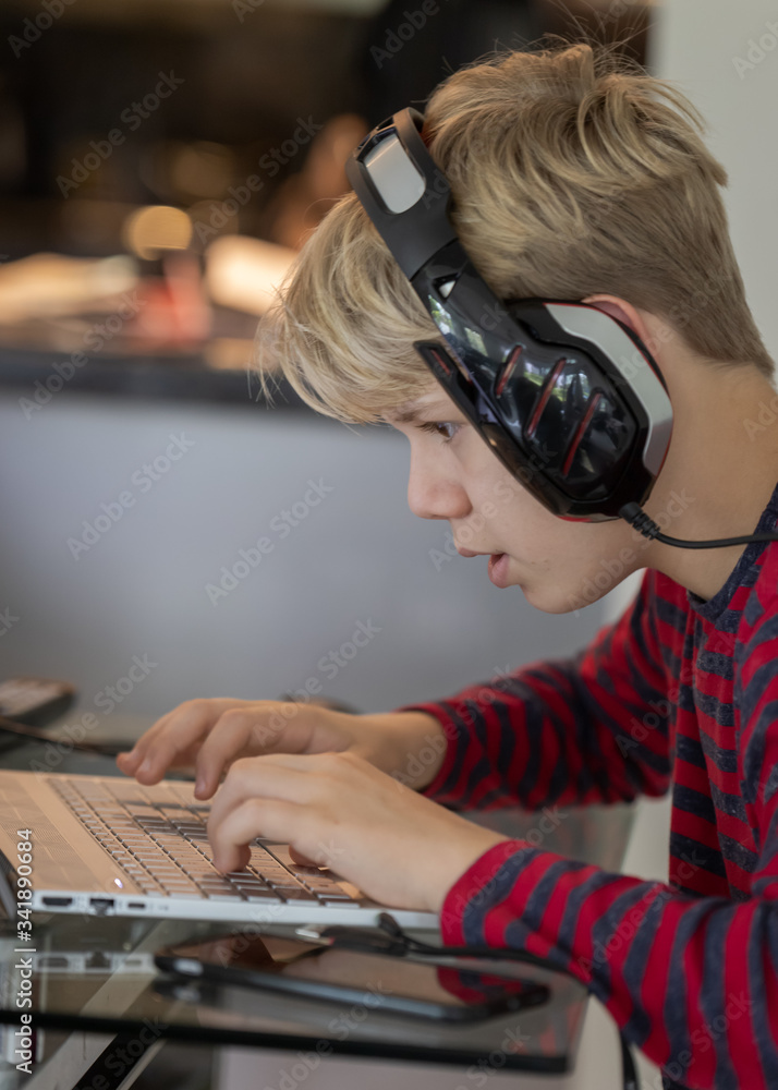 the boy is working on the computer. close up. social distancing. stay home the boy is working on the computer. close up. social distancing. stay home