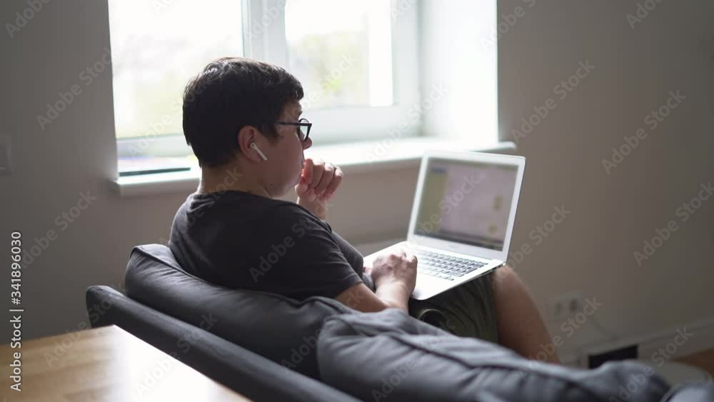 Young caucasian businessman working from home in living room on sofa. Reading bad news, get bank report, fired email. Young caucasian businessman working from home in living room on sofa. Reading bad news, get bank report, fired email.