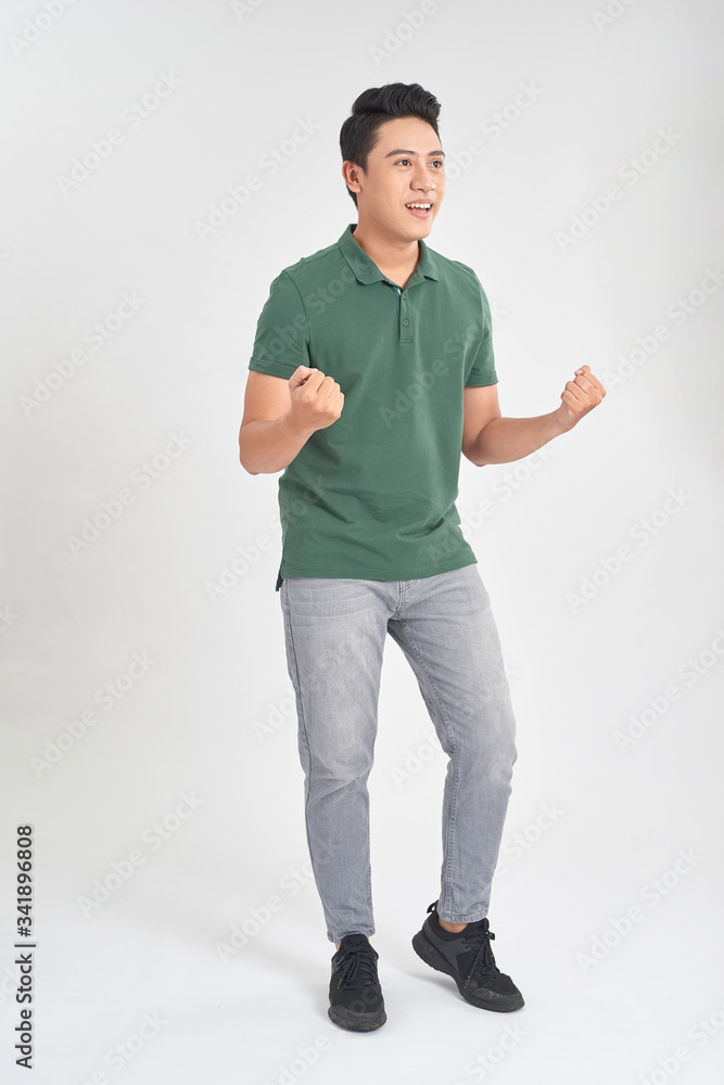 Portrait of a handsome young man cheering with arms raised isolated on white background Portrait of a handsome young man cheering with arms raised isolated on white background