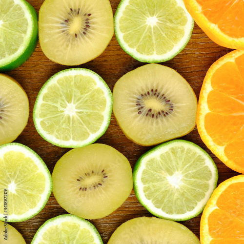 Green background with citrus-fruit of lime,Gold Kiwifruit and orange slices, Lemon texture 