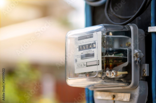Electricity meters for home electrical appliances, including blurred natural green backgrounds, electric power usage concepts, and electricity usage audits.