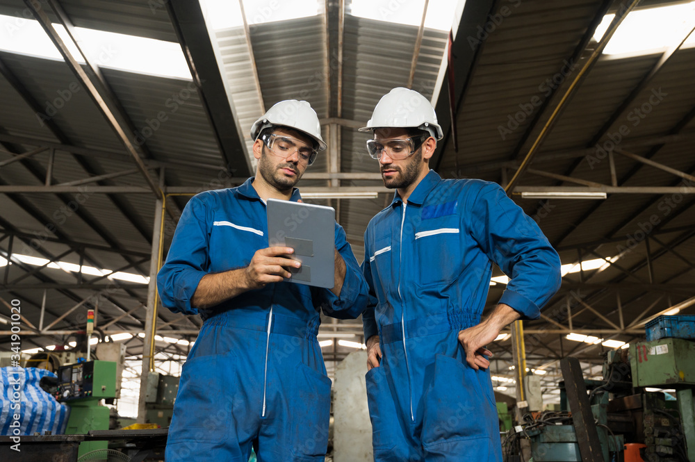 Industrial workers are working on projects in large industrial plants with many devices. Industrial workers are working on projects in large industrial plants with many devices.