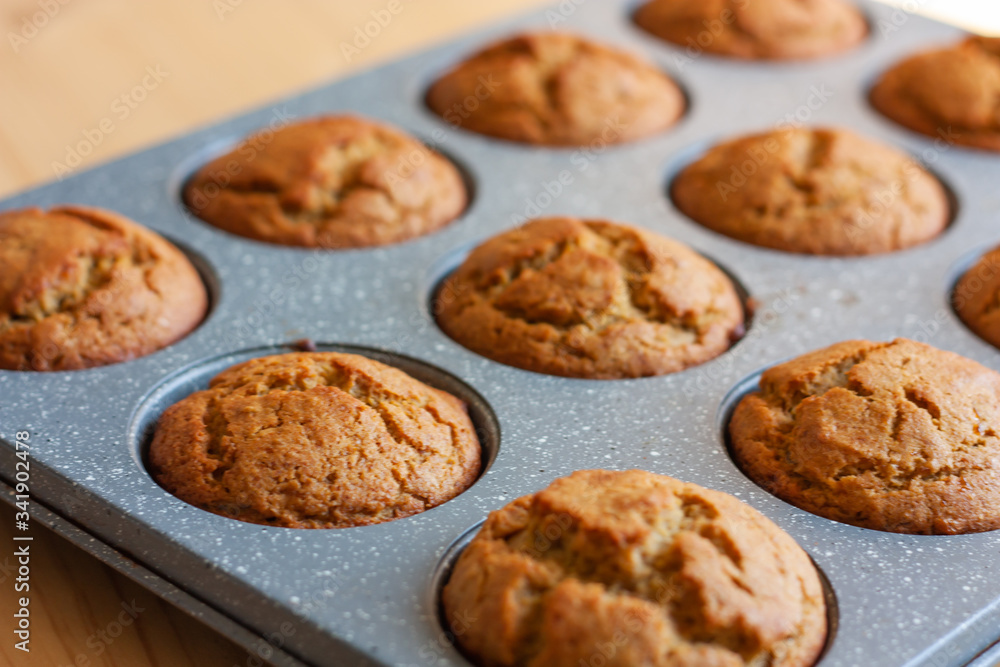 Carrot muffins in metal baking form. Homemade tasty dessert or breakfast. Healthy eating concept.  Selective focus
