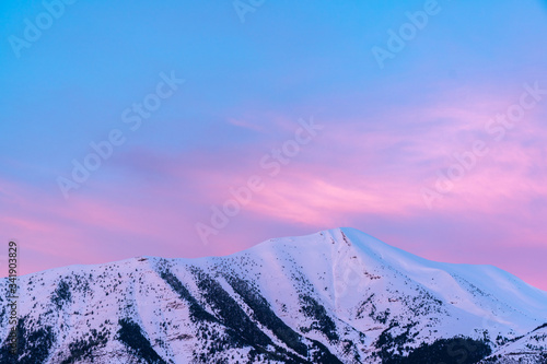 Closeup of amazing snowy mountains and red sunset, Pyrenees in Spain, copy space