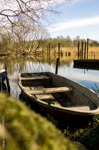 Fototapeta Naklejka Na Ścianę i Meble -  row boat towed to lake shore fishing