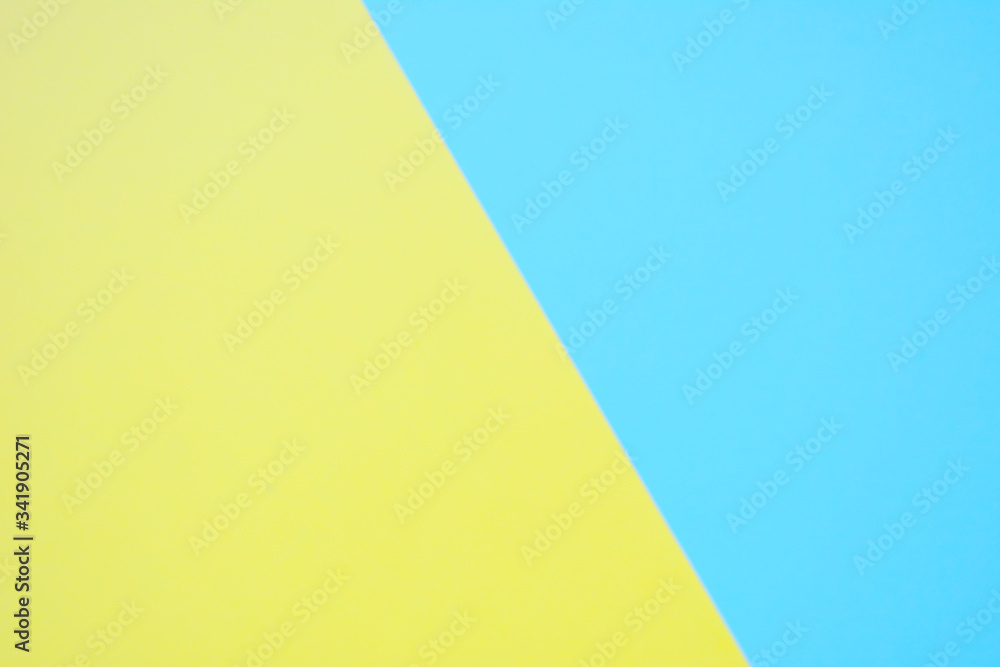 Beautiful pastel trendy yellow with blue  background. Light texture, blank
