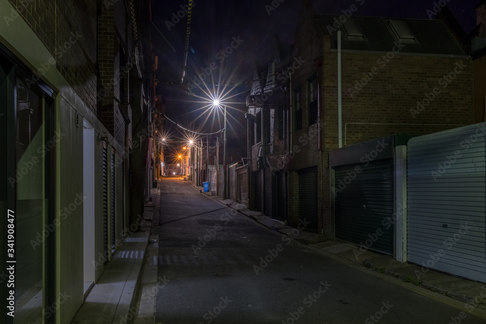 narrow empty back street at night