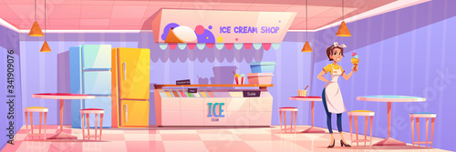Saleswoman in ice cream shop or parlor. Girl seller holding icecream cone stand near table with chairs in cafe interior with equipment fridge, showcase, banner and lamps, cartoon vector illustration