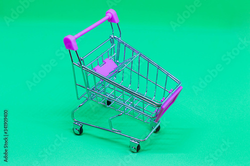 Empty self-service shopping basket isolated on green background