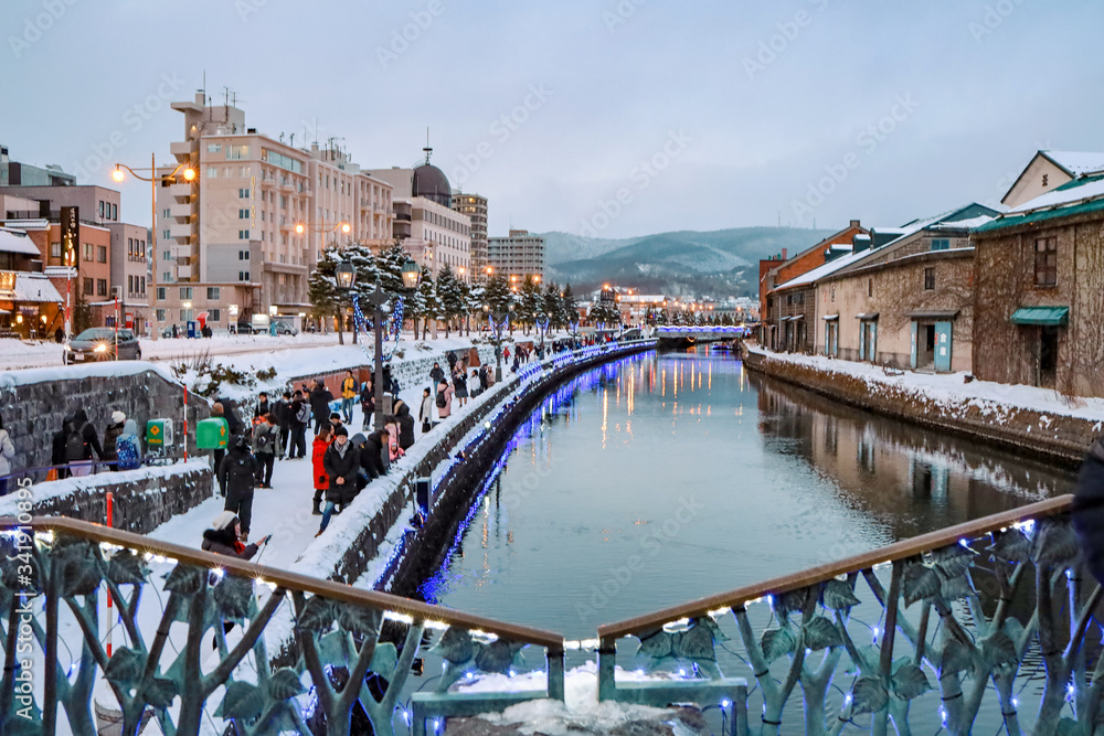 Otaru Canal in Winter with twilight light. One of Beautiful scene in Otaru canal with old warehouses. It is a popular tourist attraction of Hokkaido, Japan.