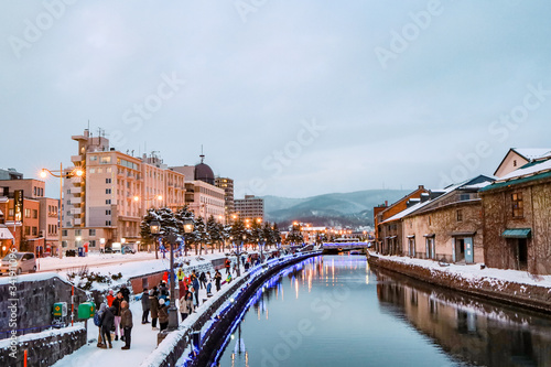 Otaru Canal in Winter with twilight light. One of Beautiful scene in Otaru canal with old warehouses. It is a popular tourist attraction of Hokkaido, Japan.