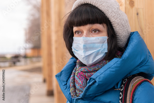 A woman in a medical mask on the street during a coronavirus.