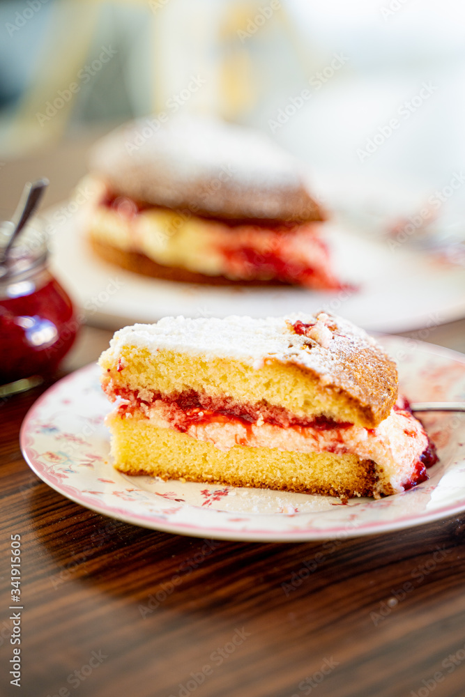 The Piece of Victoria Sponge Cake with Butter Cream and Strawberry Jam Filling The Piece of Victoria Sponge Cake with Butter Cream and Strawberry Jam Filling