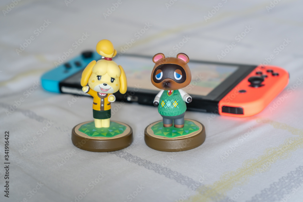 Bangkok, Thailand - March 21, 2020 : Amiibo presents Isabelle and Tom Nook,  the characters from Animal Crossing game. Amiibo, an action figure, can  interact with the Nintendo Switch game console. foto