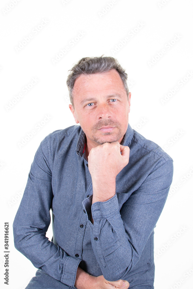 Portrait serious handsome man hand on chin over white background Portrait serious handsome man hand on chin over white background