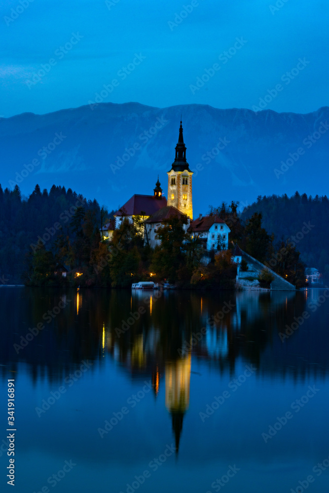 the church on bled lake at sunset