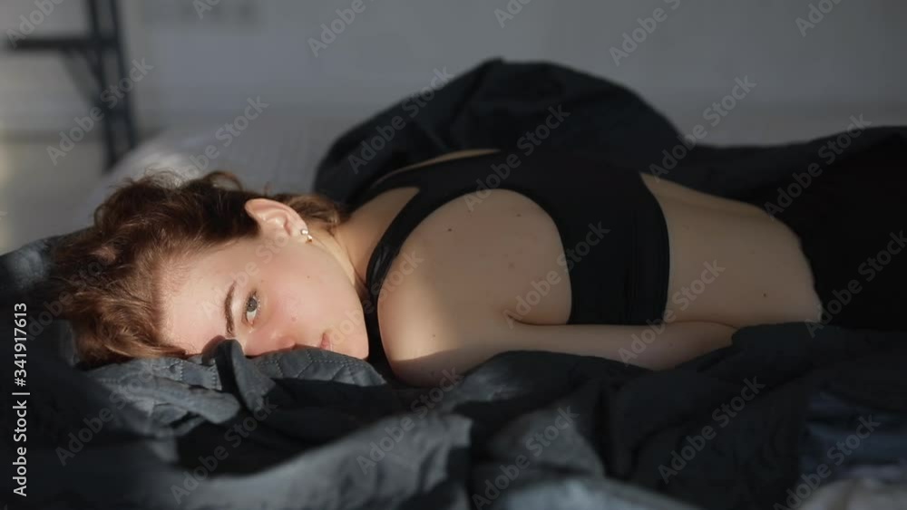 Woman lying on a bed and open her eyes Woman lying on a bed and open her eyes