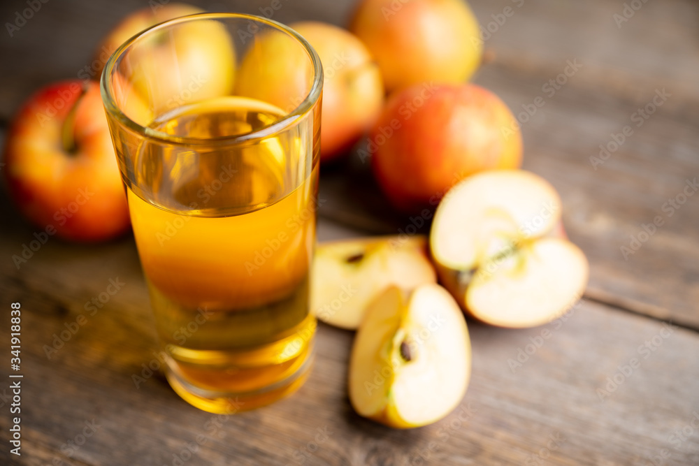 Apple juice with freshly harvested apples on the rustic background. Selective focus. Shallow depth of field. Apple juice with freshly harvested apples on the rustic background. Selective focus. Shallow depth of field.