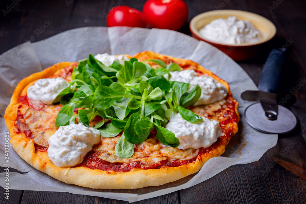 Pizza with tomatoes,corn lettuce and strachatella cheese Pizza with tomatoes,corn lettuce and strachatella cheese