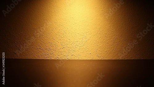 The effect of a dimmable light on a wall. The brightness of the light increases and decreases. The dimmer is set on a small led light