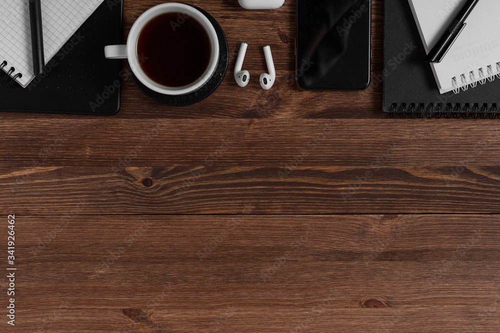 Notebook, graphics tablet, pencil and pen lie on a wooden brown table. Concept for designer or digital artist. Image with place for your text. Notebook, graphics tablet, pencil and pen lie on a wooden brown table. Concept for designer or digital artist. Image with place for your text.