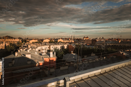 Amazing sunset on the roofs of the old district of St. Petersburg © irina