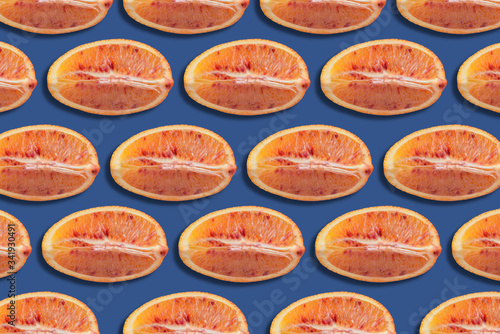 pattern of red orange slices on blue background, citrus background