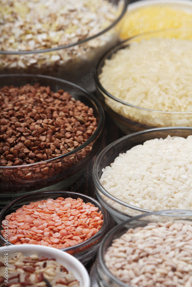 A set of bowls filled with different seeds: buckwheat, rise, corn and oatmeal A set of bowls filled with different seeds: buckwheat, rise, corn and oatmeal