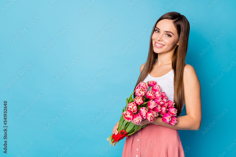Turned photo of cheerful charming lovely girl hold big tulips bouquet she receive on 8-march 14-february holiday wear good look tank-top isolated over blue color background
