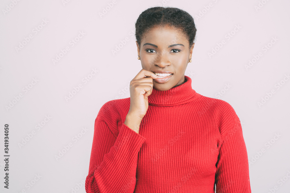 Front view of curious young woman biting finger. Cheerful female thinking about something. Curiosity concept Front view of curious young woman biting finger. Cheerful female thinking about something. Curiosity concept