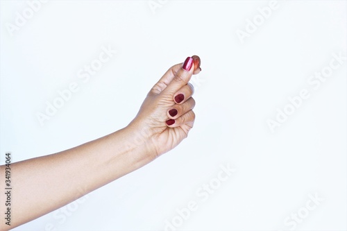 Woman hand red nail polish holding euro cent . photo isolate on white copy space