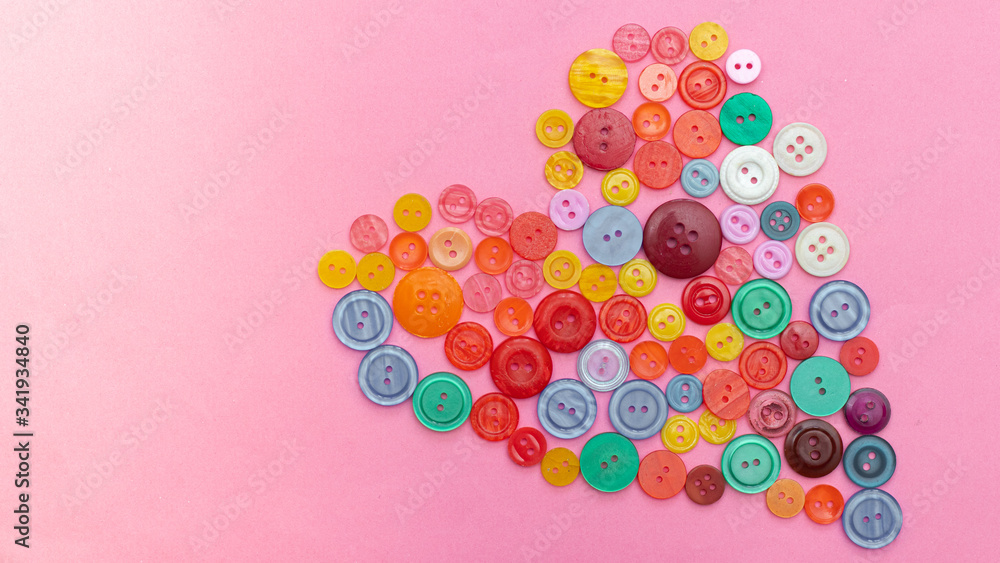 Buttons colored banner. Buttons are laid out in a heart. Heart. Valentine's Day. Hobbies and leisure. Sewing Buttons colored banner. Buttons are laid out in a heart. Heart. Valentine's Day. Hobbies and leisure. Sewing