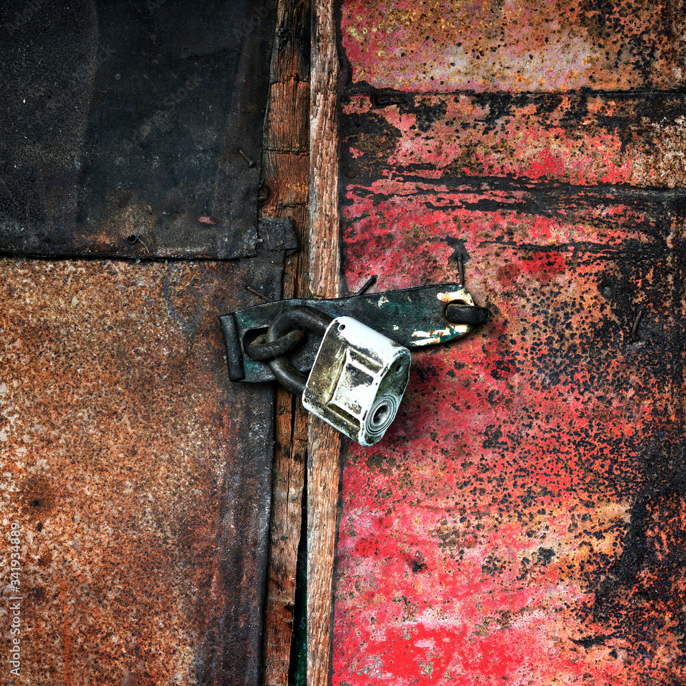 Old padlock on the door of the barn Old padlock on the door of the barn