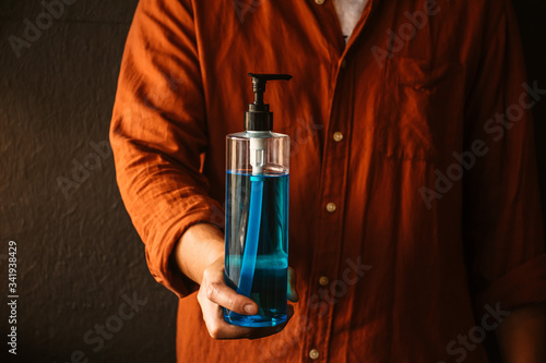 Man hands holding alcohol sanitizer gel for protecting infection from a corona virus and other viruses. photo
