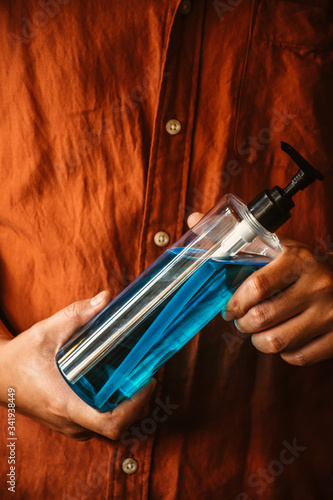 Man hands holding alcohol sanitizer gel for protecting infection from a corona virus and other viruses. photo