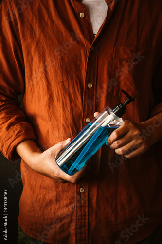 Man hands holding alcohol sanitizer gel for protecting infection from a corona virus and other viruses. photo