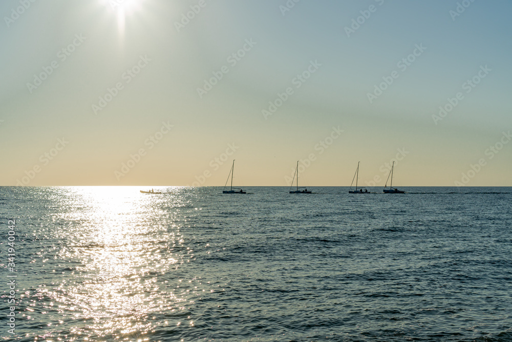 several sailing boats sailing on the horizon of the Black Sea in Sochi several sailing boats sailing on the horizon of the Black Sea in Sochi