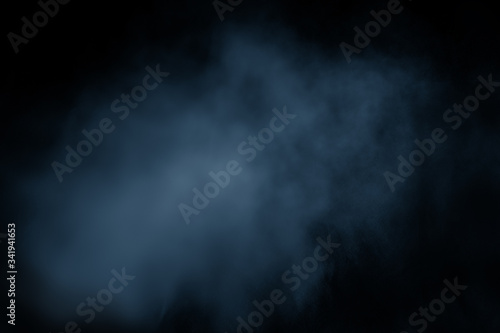 Dark blue clouds of smoke vapor isolated on black background. Gas explodes, whirls in space. abstraction, classic blue, trendy color, color 2020