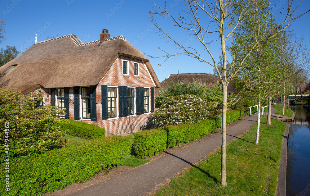 Giethoorn Overijssel Netherlands. During Corona lock-down. Empty streets, paths, bridges and canals.  Old farmhouse