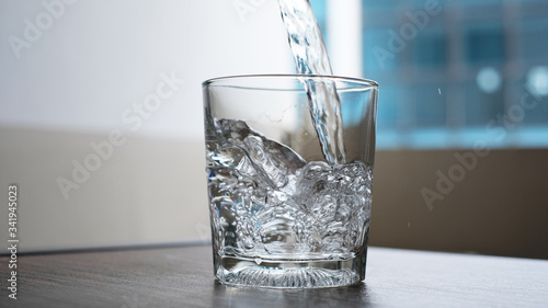 water to drink poured into a glass
