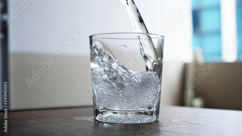 water to drink poured into a glass