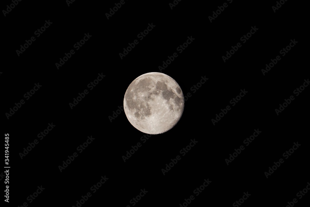 Full moon over black background sky. Supermoon captured on camera. Full details photo of moon. moon craters are visiable. Full moon over black background sky. Supermoon captured on camera. Full details photo of moon. moon craters are visiable.