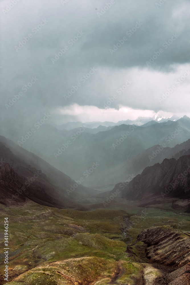 Kyrgyzstan. Karakol. Alakel. Stormy sky before a storm in the mountains. The mountains. Rain. Storm. Rocks. Beautiful thunderstorm landscape